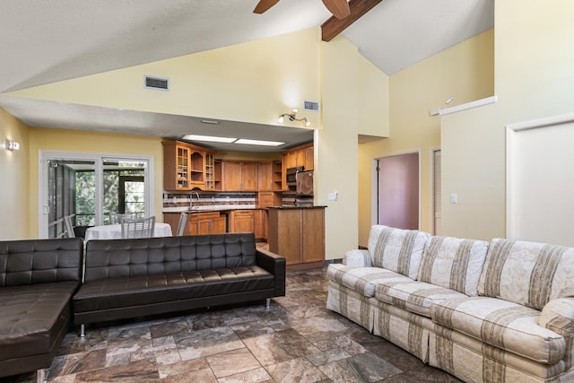 living room featuring beamed ceiling, ceiling fan, and high vaulted ceiling