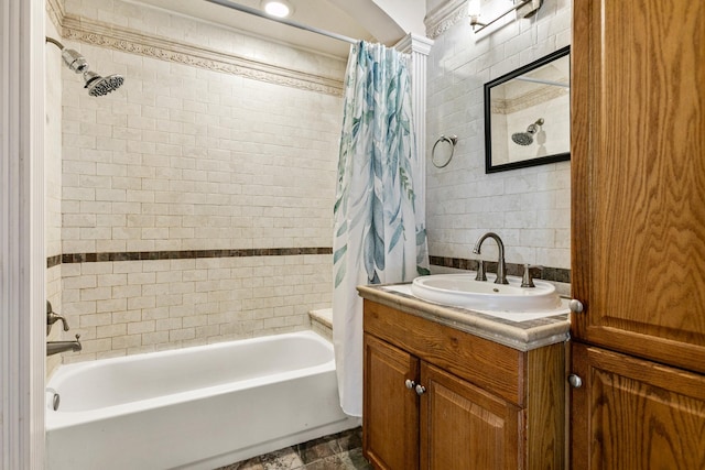 bathroom with shower / tub combo, vanity, and tile walls