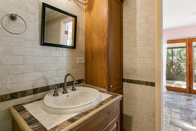 bathroom featuring vanity and backsplash