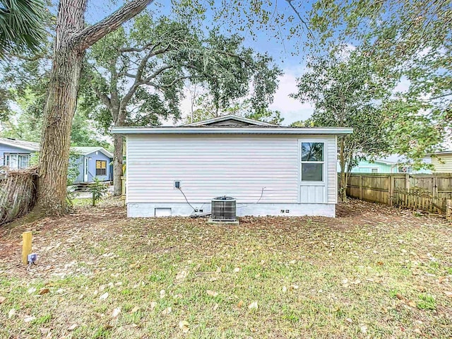 exterior space with crawl space, fence, and central air condition unit