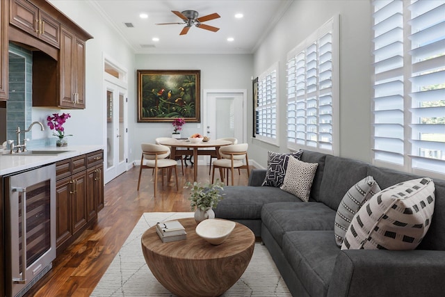 3943 NW 219th St, Rdd, Micanopy, FL 32667 - living room featuring wine cooler, plenty of natural light, dark wood-style floors, a ceiling fan, and ornamental molding