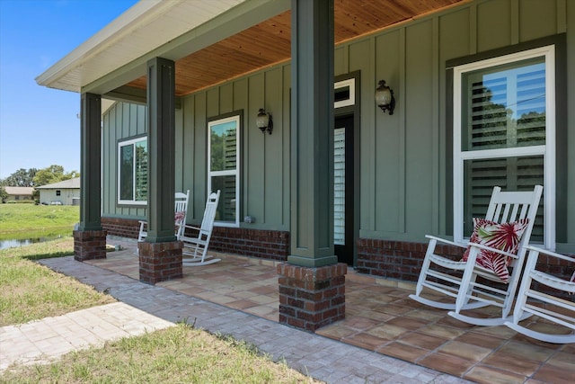 3943 NW 219th St, Rdd, Micanopy, FL 32667 - entrance to property featuring a porch, board and batten siding, and brick siding