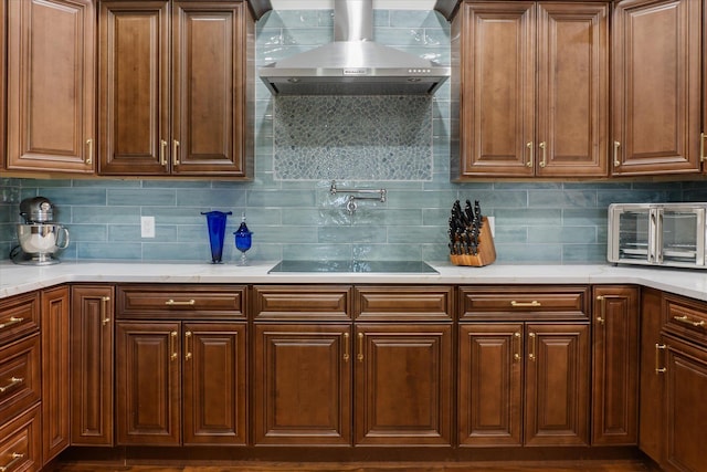 3943 NW 219th St, Rdd, Micanopy, FL 32667 - kitchen with wall chimney exhaust hood, black electric cooktop, and backsplash