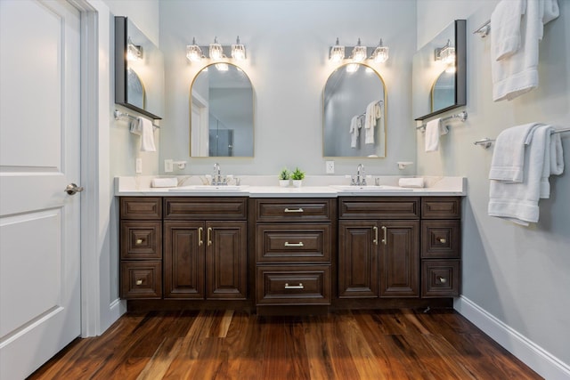 3943 NW 219th St, Rdd, Micanopy, FL 32667 - bathroom featuring double vanity, wood finished floors, and baseboards