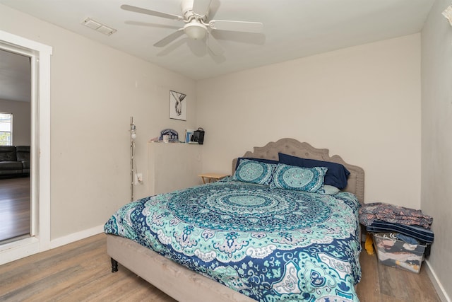 bedroom with hardwood / wood-style floors and ceiling fan