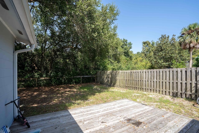 wooden terrace featuring a yard