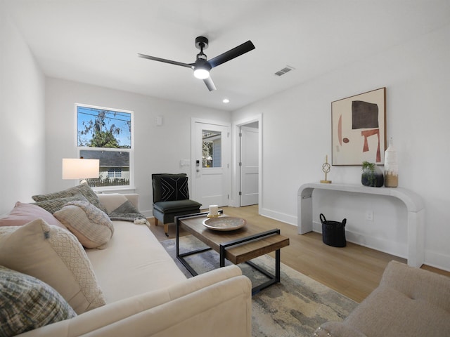 living room featuring ceiling fan and light wood-type flooring