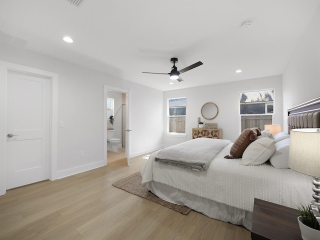 bedroom with ceiling fan, connected bathroom, and light wood-type flooring