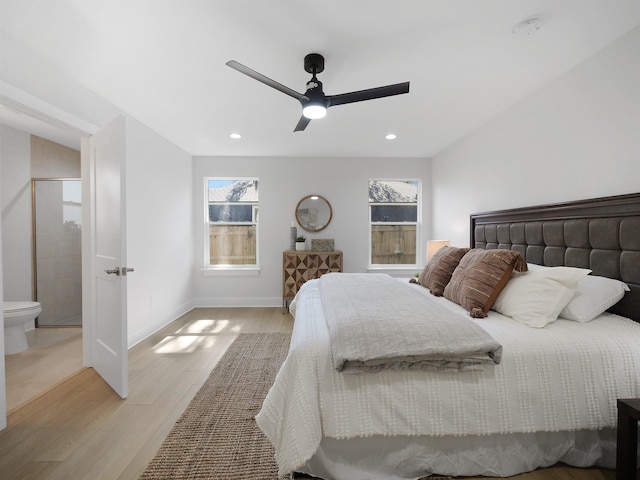 bedroom featuring multiple windows, ceiling fan, and light wood-type flooring