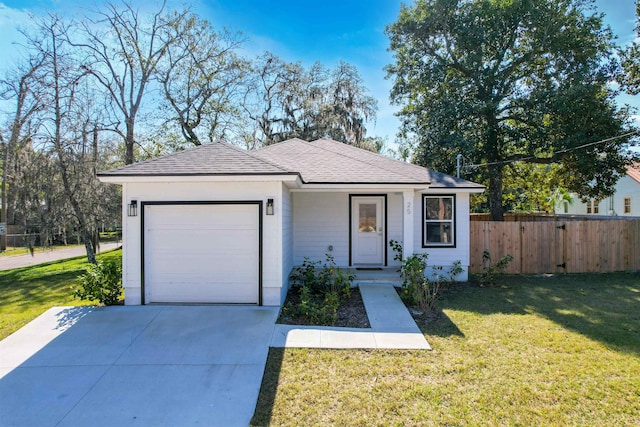 view of front of house with a garage and a front yard