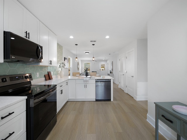 kitchen featuring dishwasher, electric range, white cabinets, decorative light fixtures, and kitchen peninsula