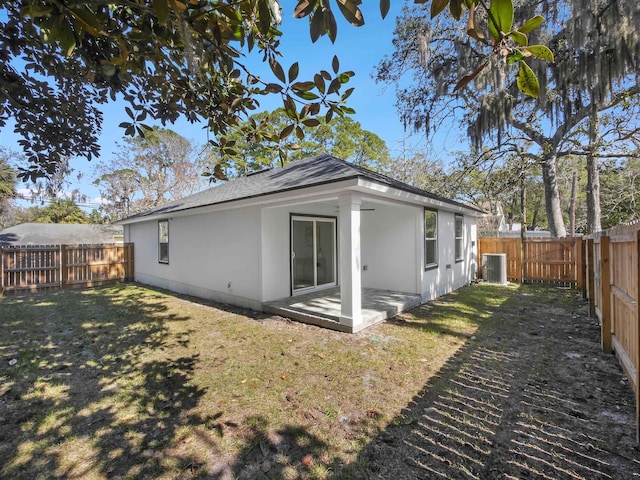 back of house with a patio area, central AC unit, and a lawn