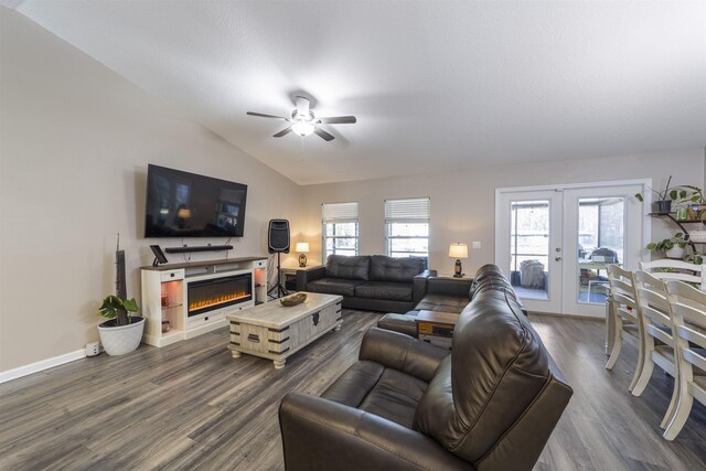 living room featuring ceiling fan, french doors, dark wood-type flooring, and vaulted ceiling