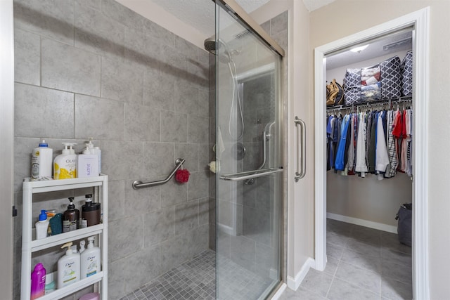 bathroom with a textured ceiling and walk in shower