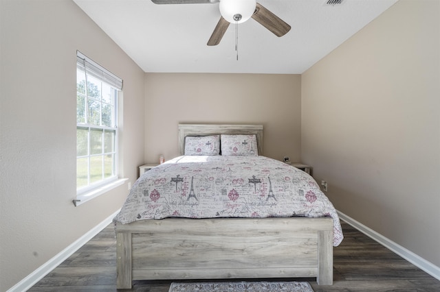 bedroom with ceiling fan and dark wood-type flooring