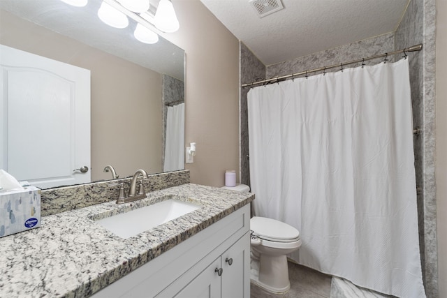 bathroom with tile patterned floors, a textured ceiling, toilet, vanity, and a shower with shower curtain