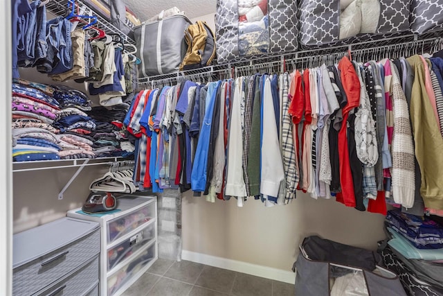 walk in closet with tile patterned floors