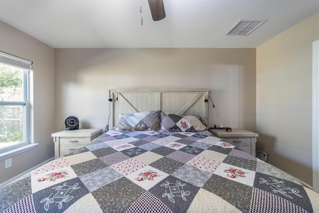 bedroom with multiple windows and ceiling fan