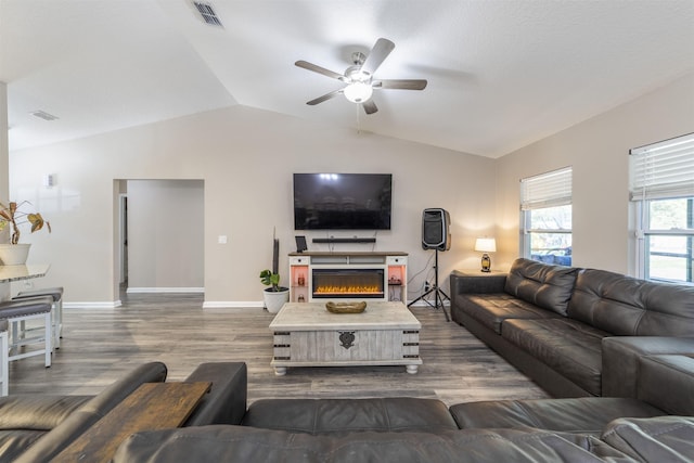 living room with lofted ceiling, ceiling fan, and dark hardwood / wood-style floors