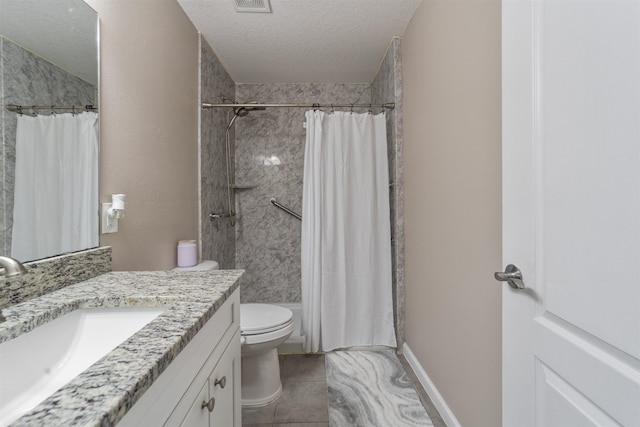 bathroom with vanity, tile patterned floors, toilet, a textured ceiling, and curtained shower