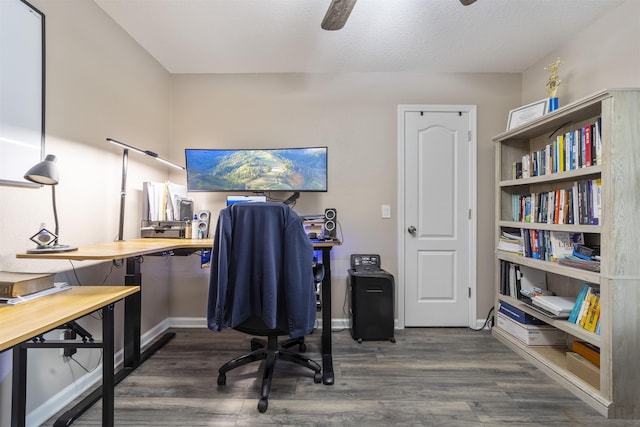 office space with ceiling fan and dark wood-type flooring