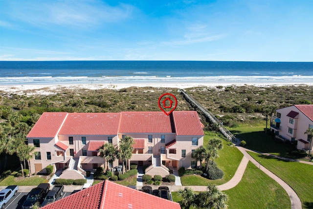 bird's eye view with a water view and a view of the beach