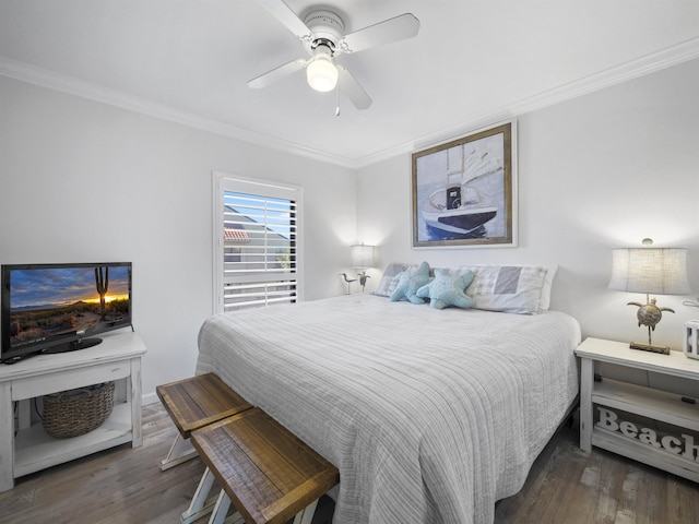 bedroom featuring dark hardwood / wood-style flooring, ornamental molding, and ceiling fan