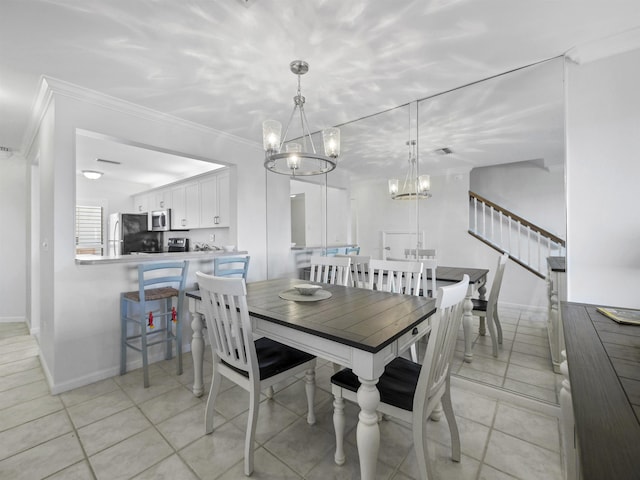 dining room featuring an inviting chandelier, ornamental molding, and light tile patterned flooring