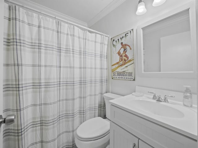 bathroom with crown molding, vanity, and toilet