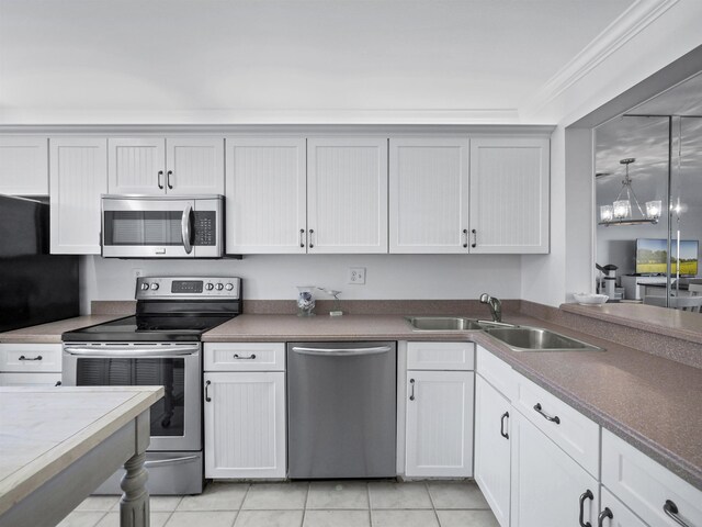 kitchen featuring appliances with stainless steel finishes, sink, and white cabinets