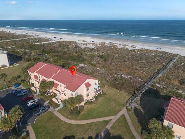 bird's eye view featuring a water view and a beach view