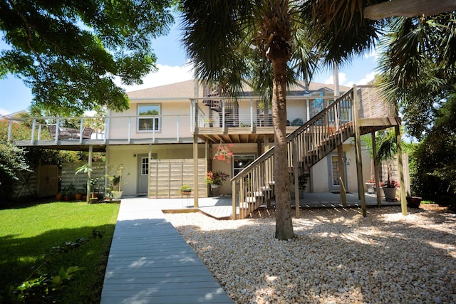 back of property featuring a patio and a lawn