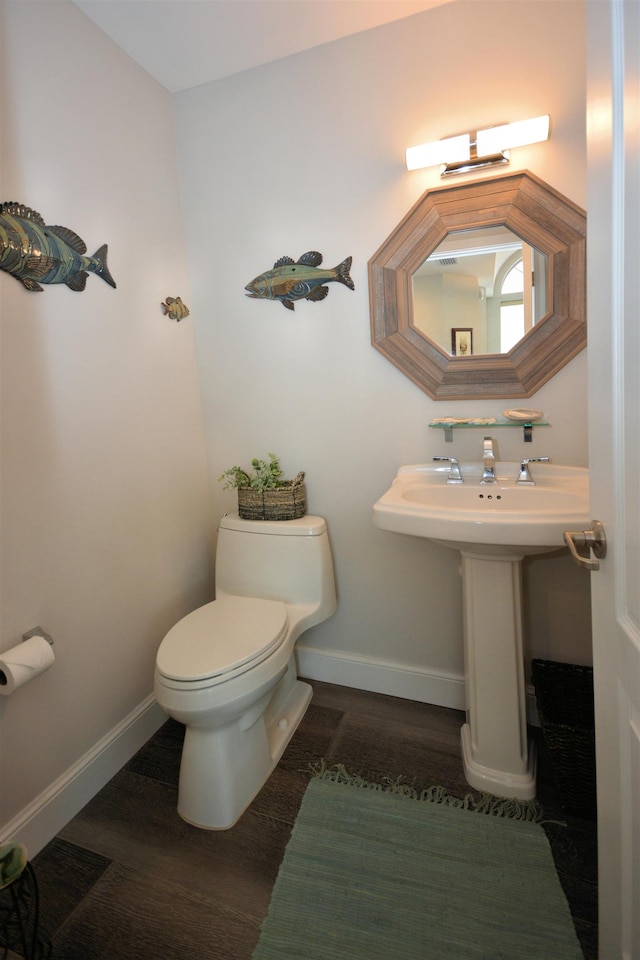 bathroom with sink, toilet, and hardwood / wood-style flooring