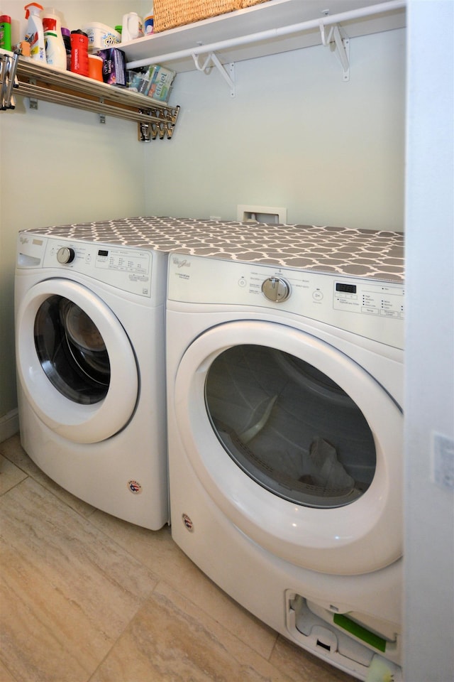 washroom with washing machine and clothes dryer