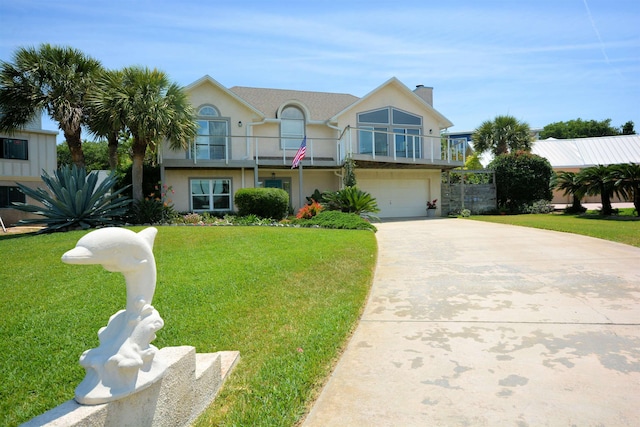 view of front of house with a balcony, a front yard, and a garage