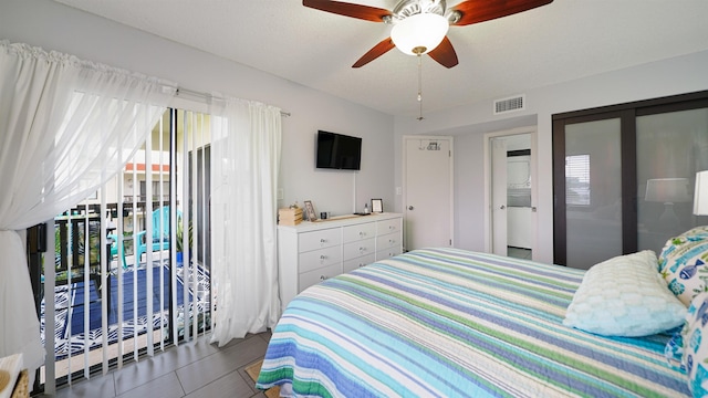 tiled bedroom with access to exterior, multiple windows, and ceiling fan