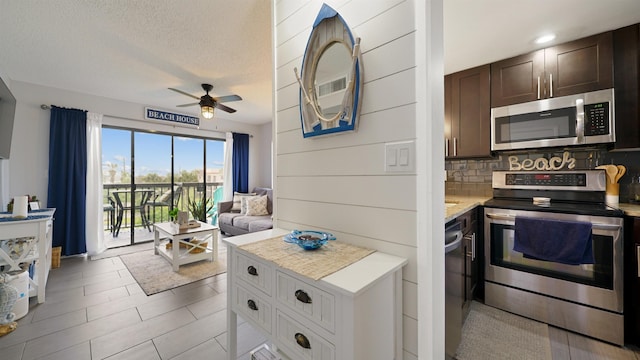 kitchen featuring appliances with stainless steel finishes, tasteful backsplash, dark brown cabinets, a textured ceiling, and ceiling fan