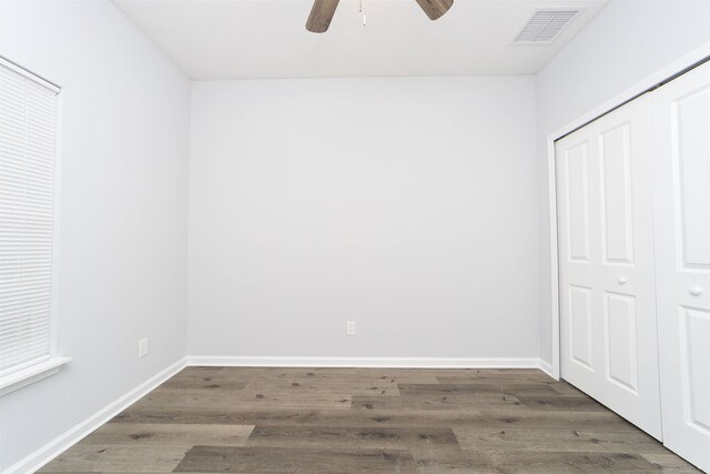 679 Coral Cir, Saint Augustine, FL 32080 - unfurnished bedroom with a closet, wood finished floors, and a ceiling fan
