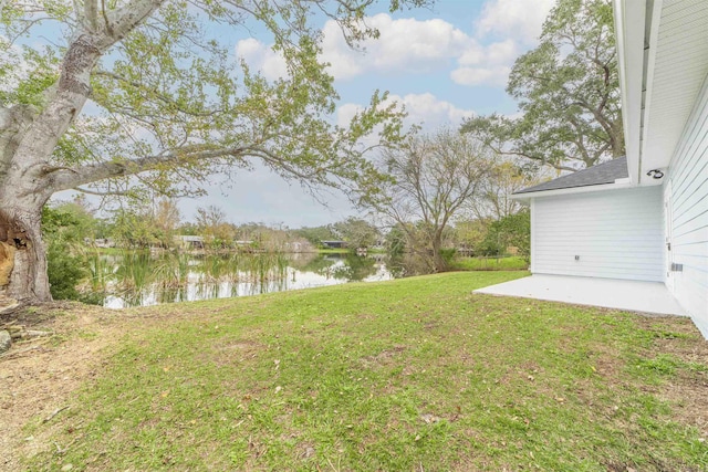 view of yard featuring a patio area and a water view