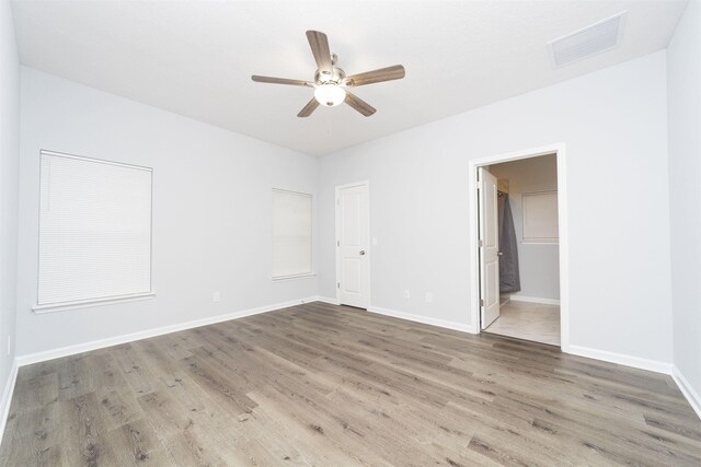 spare room with hardwood / wood-style flooring and ceiling fan