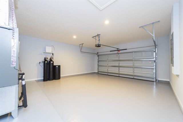 679 Coral Cir, Saint Augustine, FL 32080 - garage with recessed lighting, a garage door opener, and electric panel