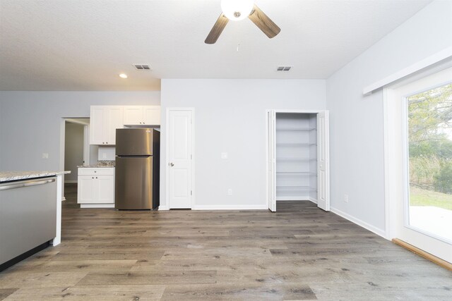 679 Coral Cir, Saint Augustine, FL 32080 - unfurnished bedroom with freestanding refrigerator, recessed lighting, wood finished floors, access to exterior, and ceiling fan