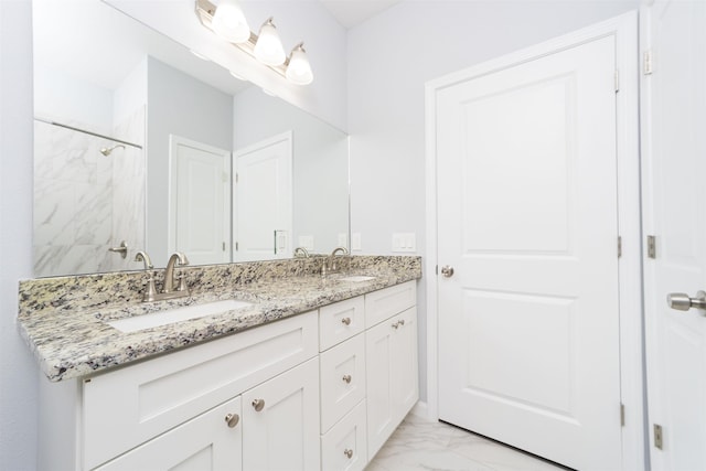 679 Coral Cir, Saint Augustine, FL 32080 - bathroom with double vanity, marble finish flooring, and a shower