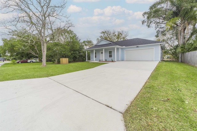 ranch-style house with covered porch, a garage, and a front yard