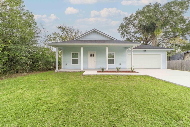 view of front of property featuring a front yard, a garage, and covered porch