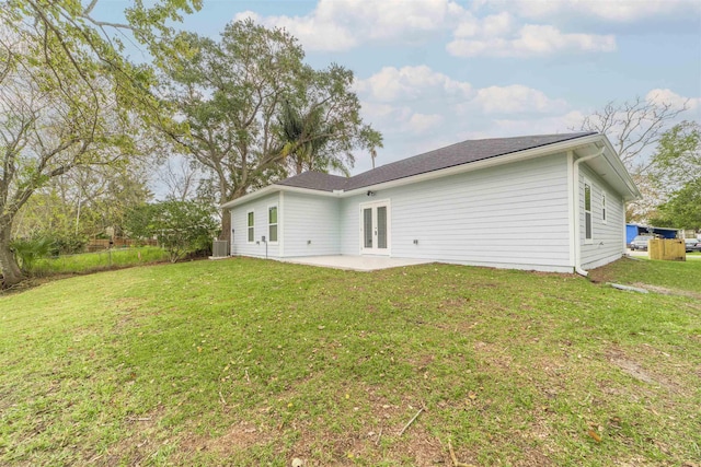 back of house featuring french doors, a patio, central AC unit, and a lawn