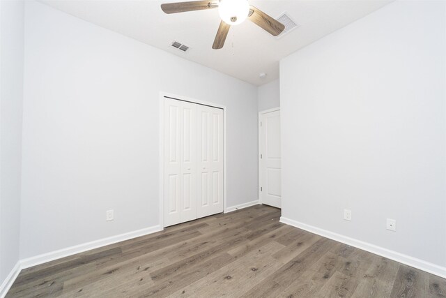 679 Coral Cir, Saint Augustine, FL 32080 - unfurnished bedroom featuring wood finished floors, a closet, and a ceiling fan
