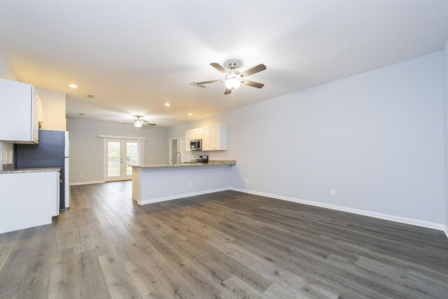 679 Coral Cir, Saint Augustine, FL 32080 - unfurnished living room with ceiling fan, dark wood-type flooring, recessed lighting, and french doors