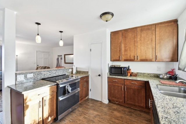5455 1st St, Saint Augustine, FL 32080 - kitchen with double oven range, a sink, a peninsula, dark wood finished floors, and pendant lighting