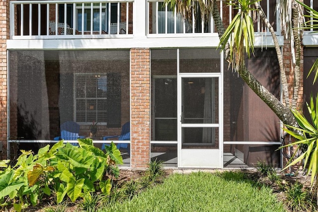 rear view of property with a sunroom